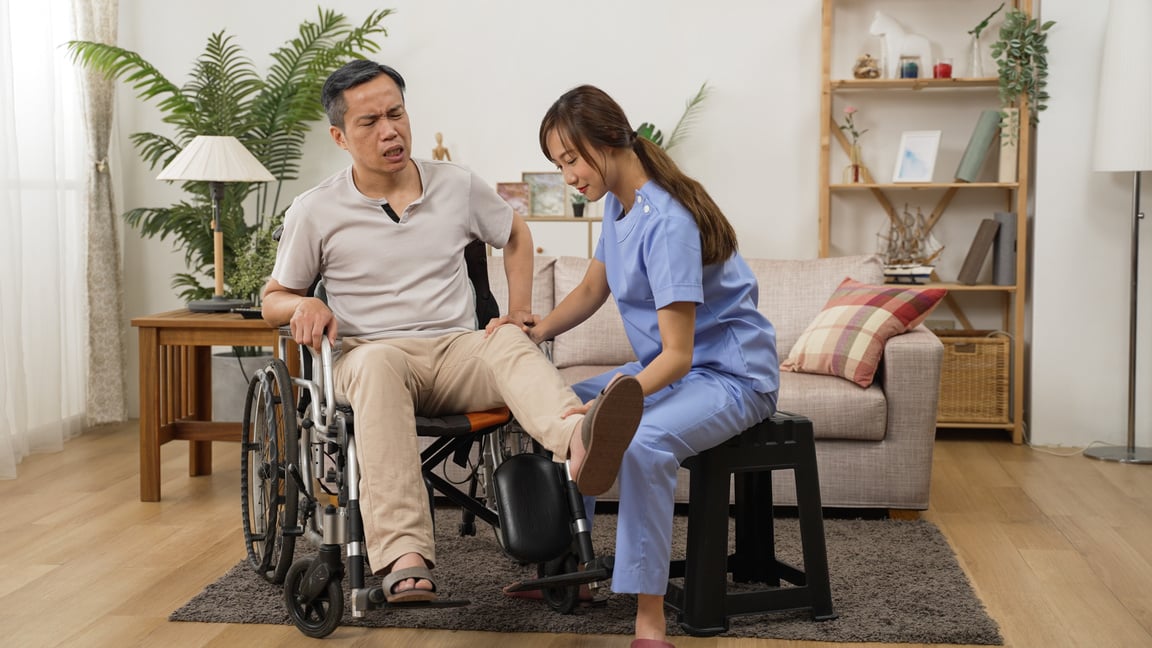 Asian Female Care Attendant Helping Senior Man on Wheelchair Doi